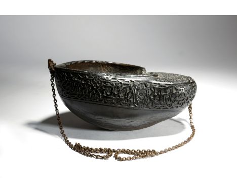 A Sufi Dervish Coco de Mer begging bowl or kashkul, relief carved with scrolling leaves, flowers, with portrait busts and pan
