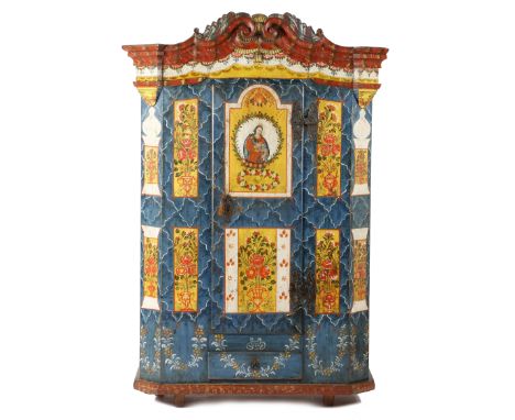 A Bohemian painted pine armoire, polychrome decorated with panels of urns of flowers and a central panel depicting a portrait