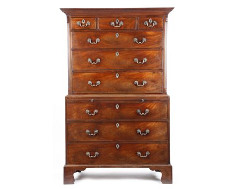 An early George III mahogany chest on chest, the moulded cornice above three short and three long drawers, flanked by fluted 