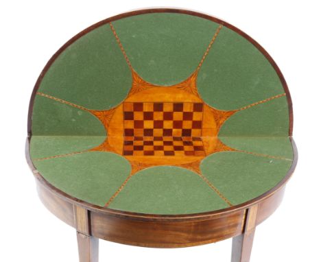 λ A George III mahogany card / games table, inlaid with boxwood stringing and rosewood banding, the demi-lune hinged top inla