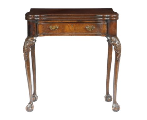 A walnut card table in George II style, the hinged top on twin gate supports revealing a baize lined playing surface, with fo