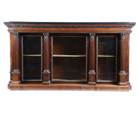 A mahogany architectural breakfront bookcase, the detachable ebony top above a finely carved cornice with leaf and egg and da