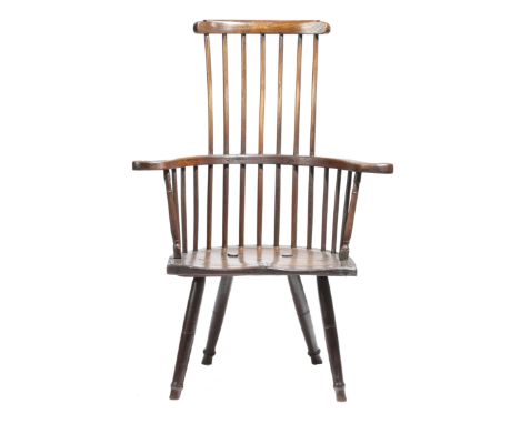 An early 19th century and later elm primitive Windsor armchair, the later comb top rail above a stick back and scroll arms, p