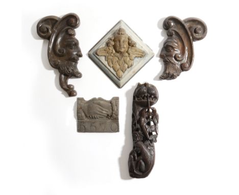 A pair of Italian stained pine architectural fragments, each carved with 'C' scrolls and a bearded man, 18th century, togethe