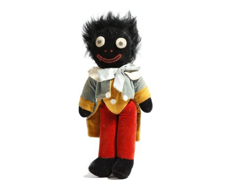 An early 20th century velvet and mohair golliwog doll, probably by Chad Valley, 29cm long.