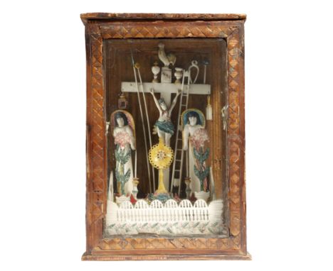 An early 19th century French prisoner of war bone Calvary model, with polychrome decoration, depicting Christ on the cross wi
