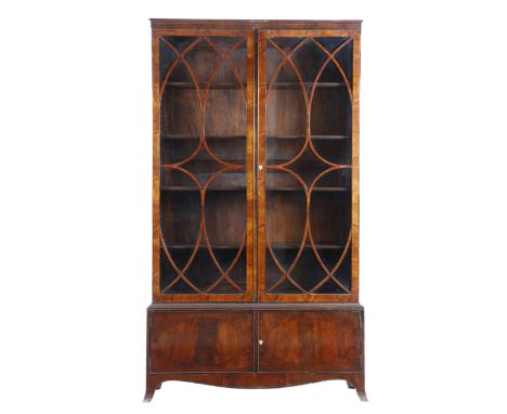 A matched pair of mahogany bookcases in Regency style, each with a pair of astragal glazed doors enclosing three adjustable s