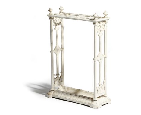 A Victorian white painted cast iron stick / umbrella stand, with four circular divisions and a lift-out tray with a registrat