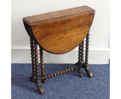 A Victorian walnut 'bobbin' Sutherland Table, the oval top raised on bobbin turned supports with castors, W 71cm x D 56cm x H