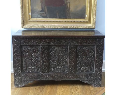 A 17thC carved oak Coffer, the hinged lid opening to a spacious interior, above a three panel front with carved decoration, r