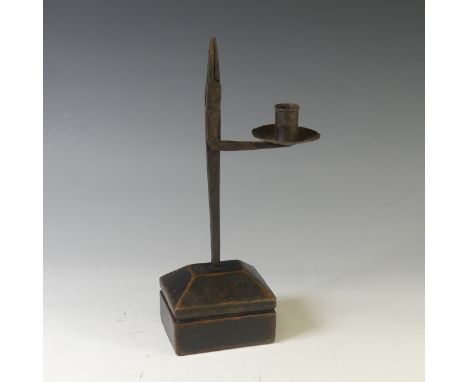 An antique wrought iron 'Pearman' Lamp or Rush Light,&nbsp;the hinged nips with attached candle sconce, raised on a rectangul