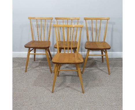 A set of four vintage Ercol stick back Dining Chairs, having a rounded seat and stick backrest attached to the top rail, rais
