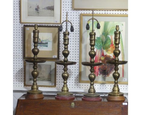 &nbsp;A pair of heavy Oriental turned brass Table Lamps, with bobbin turned shafts, drip trays and circular bases on wooden p