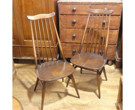 A pair of vintage Ercol 'Goldsmith' Dining Chairs,&nbsp;having a rounded seat and stick backrest attached to the top rail, ra