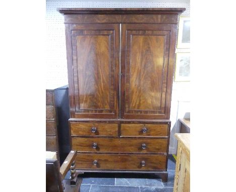 A Georgian mahogany Linen Press,&nbsp;the doors opening to reveal fitted slides, upon two short and two long drawers, all rai