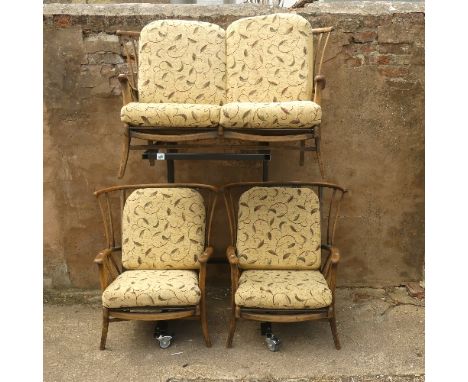A mid-20thC stick-back Three-Piece Suite, comprising a two seater Sofa and two Armchairs, the sofa W 131cm x D 74cm x H 85cm,