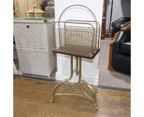 An early 20thC oak and brass Magazine Rack, the two compartments with brass mesh divisions, raised on brass tripod base, W 39