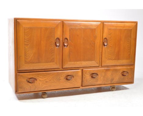 Lucian Ercolani for Ercol - Model 366 - A 20th century Ercol beech and elm sideboard credenza. The sideboard comprises a figu