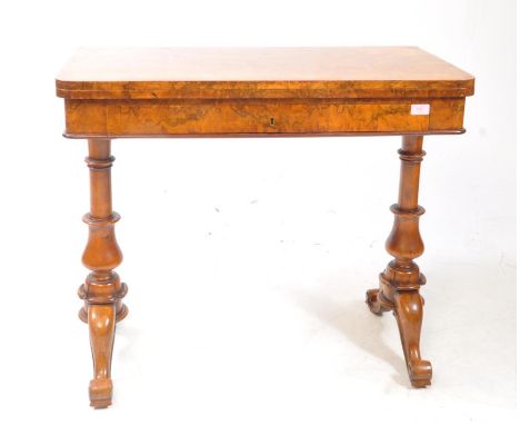 A High Victorian 19th-century burr walnut games - card table. The table with an extendable fold over baize lined hinged top o