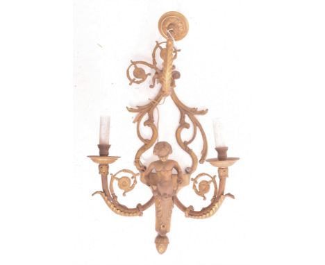 A French Louis XVI style 20th century brass cherub wall sconce light. The sconce having a ram head scrolled detail atop with 