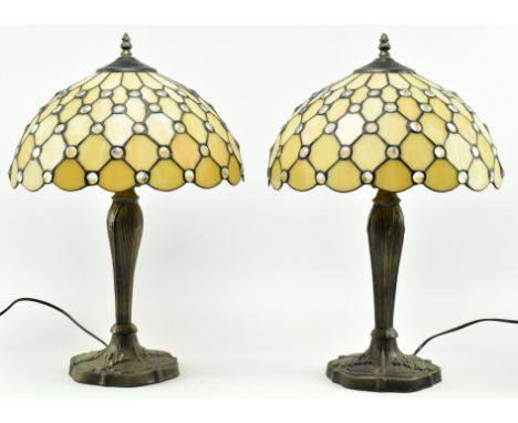 A pair of Tiffany style 20th century glass &amp; metal bedside table lamps lights. Each having a shaped finial atop over a gl