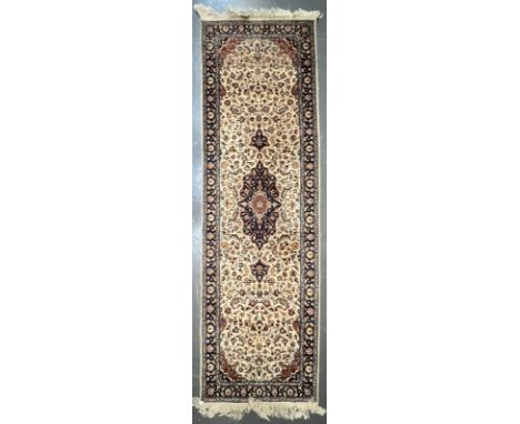 A 20th century Afghan Persian floor carpet runner rug. The runner having a central medallion on blue ground surrounded by cen