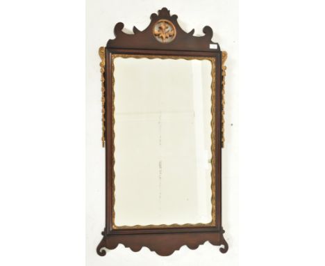 A large Victorian 19th century mahogany and gilt painted pier wall hanging mirror. The mirror having a scrolled pediment atop