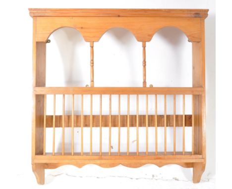 A 19th century Victorian revival wall shelf / plate rack. The rack with pediment top having arched sectioned shelf, spindle f