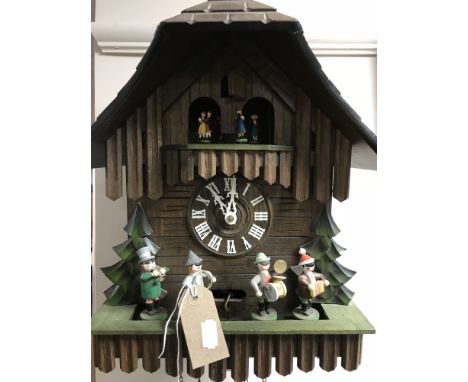 A German cuckoo clock with pendulum and weights  CONDITION REPORT: The chime function seems to be working fine, as does the c