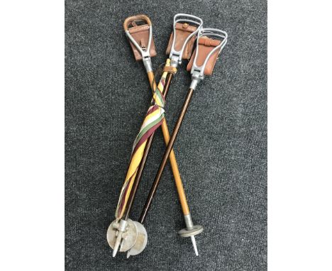 A combined umbrella/shooting stick, together with two other shooting sticks