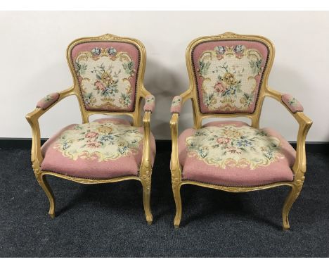 A pair of gilt salon armchairs upholstered in a floral tapestry fabric 