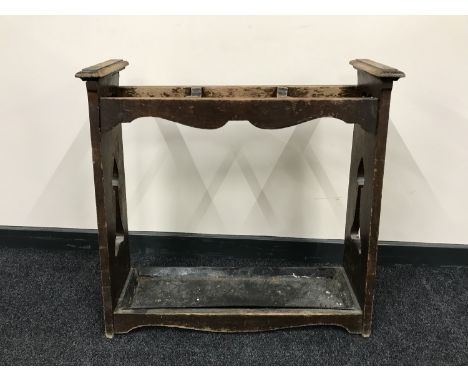 An oak Art Nouveau stick stand with metal tray  