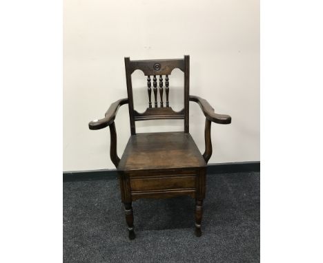 A late Victorian mahogany commode armchair