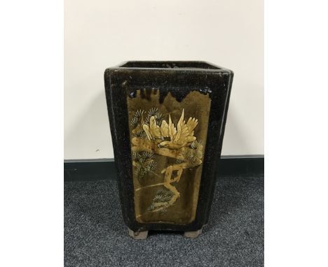A Chinese earthenware glazed planter with panels depicting bamboo and birds, height 44 cm.