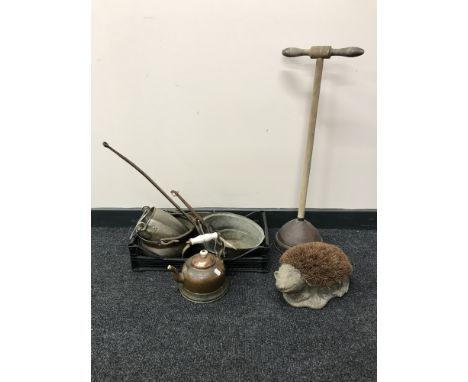 A box containing antique metalware including pans, a kettle, together with a poss stick and hedgehog boot scraper 