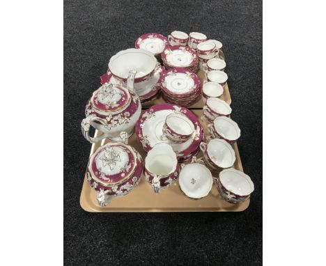 A tray containing an antique pink, white and gilt fifty six piece tea service 
