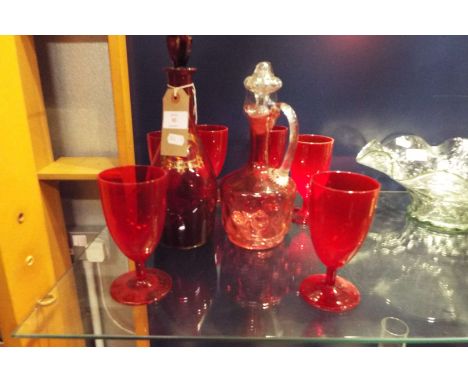 A ruby red glass port decanter and six glasses, and a cranberry decanter  Cranberry decanter has a crack approx 1 1/4" long a