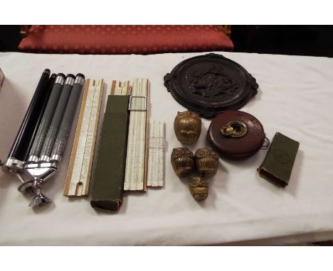 A selection of miscellaneous items to include vintage folding photography tripods, circular plaque depicting putti musicians,