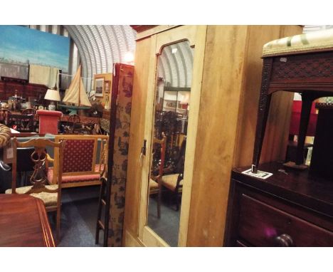 A late Victorian pine wardrobe the moulded cornice over a panelled frieze and single mirrored drawer above a single long draw