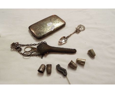 A box of assorted items to include thimbles, spoon etc