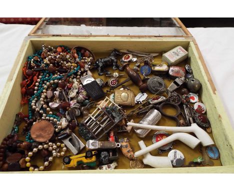 A selection of miscellaneous items to include silver brooches, costume jewellery, cork screws, enamel badges, lead farm figur