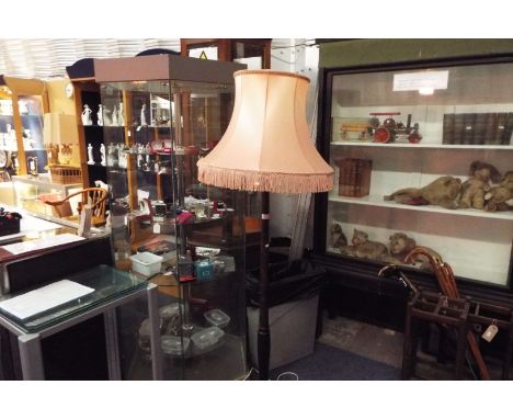 A mid-20thC turned mahogany standard lamp and shade