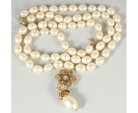 A VERY GOOD CHANEL LONG, LARGE PEARL NECKLACE, sixty six pearls with enamel pendant and large pearl. Stamped Chanel, Made in 