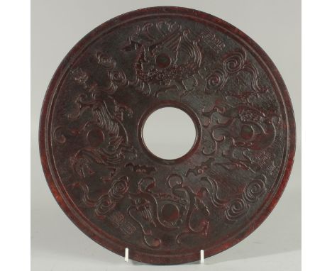 A LARGE CARVED CHINESE JADE DISC carved on both sides. 11.5ins diameter.