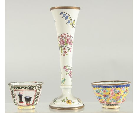 A SMALL ENAMEL SPECIMEN VASE painted with flowers. 5.25ins high and two enamel cups.