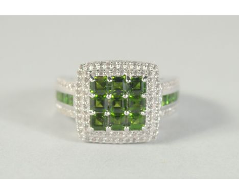 A SILVER, GREEN STONE AND CZ RING.