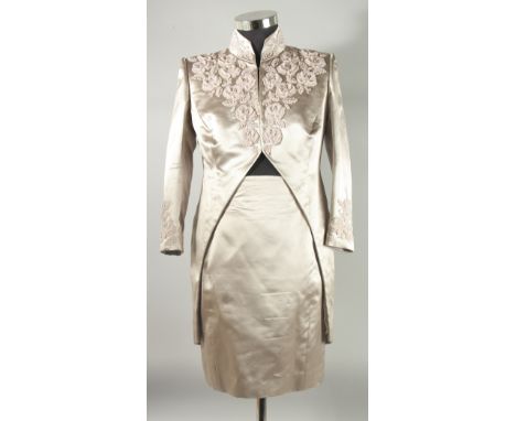 A CATHERINE WALKER TWO PIECE SILK TAUPE SKIRT AND JACKET SUIT, a plain skirt and tailed jacket with seed pearl style decorati