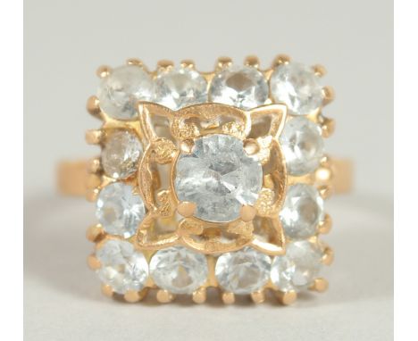 A GOOD 18CT GOLD AQUAMARINE SET SQUARE, CLUSTER RING.