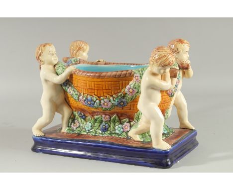 A MAJOLICA DESIGN POTTERY PLANTER a bowl held by four cupids on a blue base. 12ins high.
