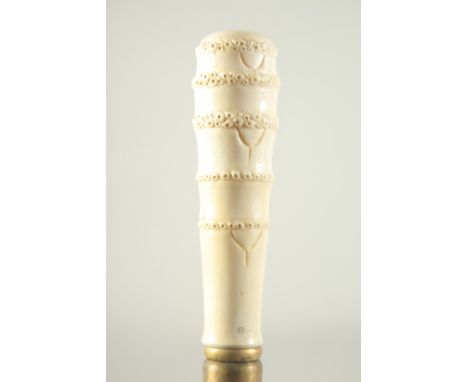 A WALKING STICK with carved bone handle, 'FAUX BAMBOO'.